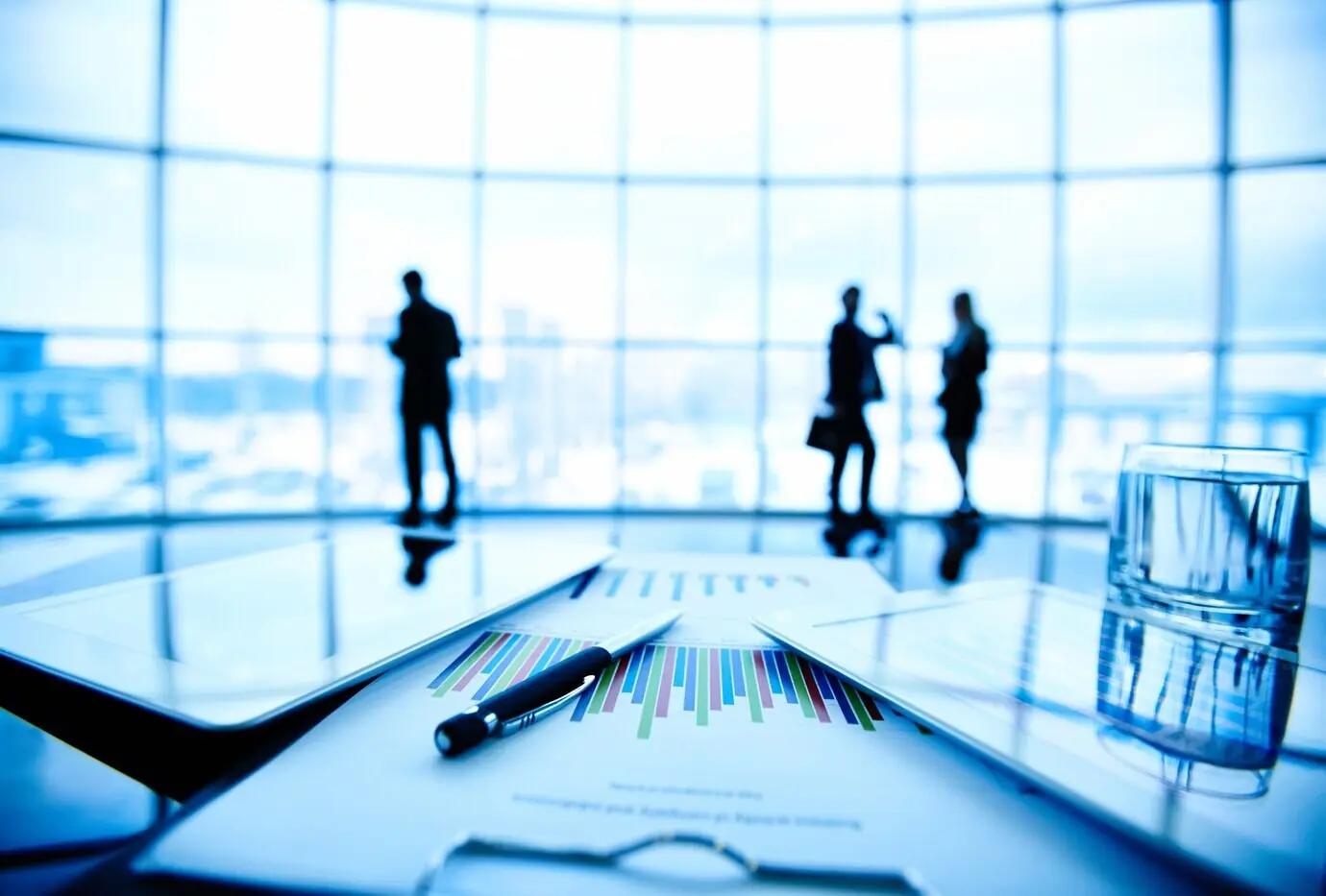 Планшет и документы на столе крупным планом.